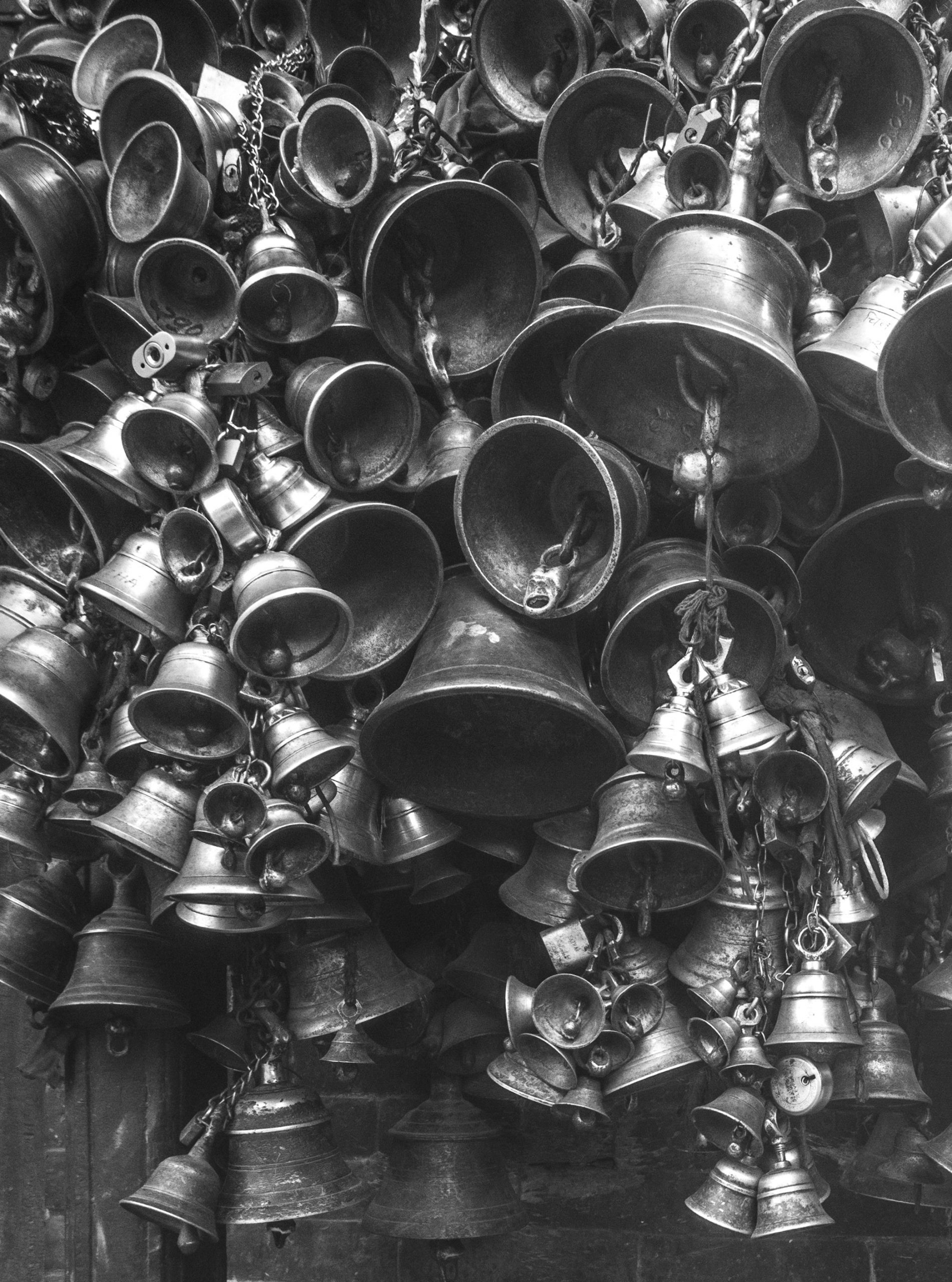 many bells next to each other ringing in ears