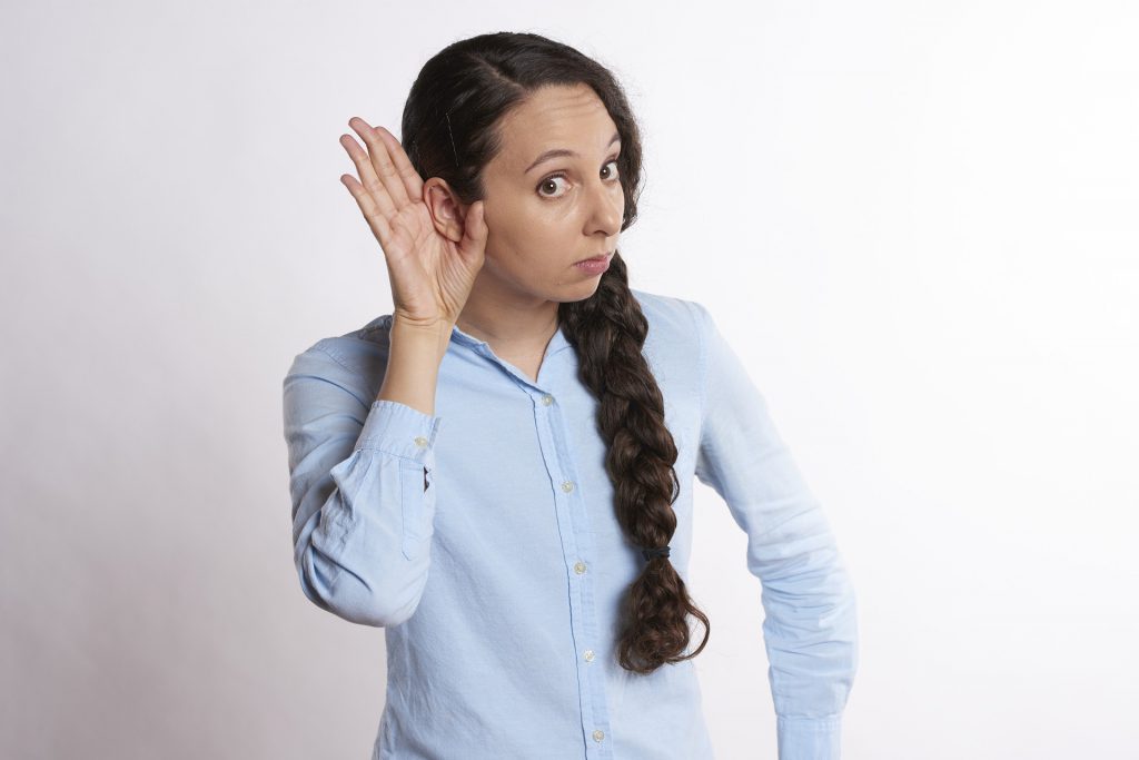 About Hearing Loss. Single-Sided Deafness with woman holding hand behind her right ear