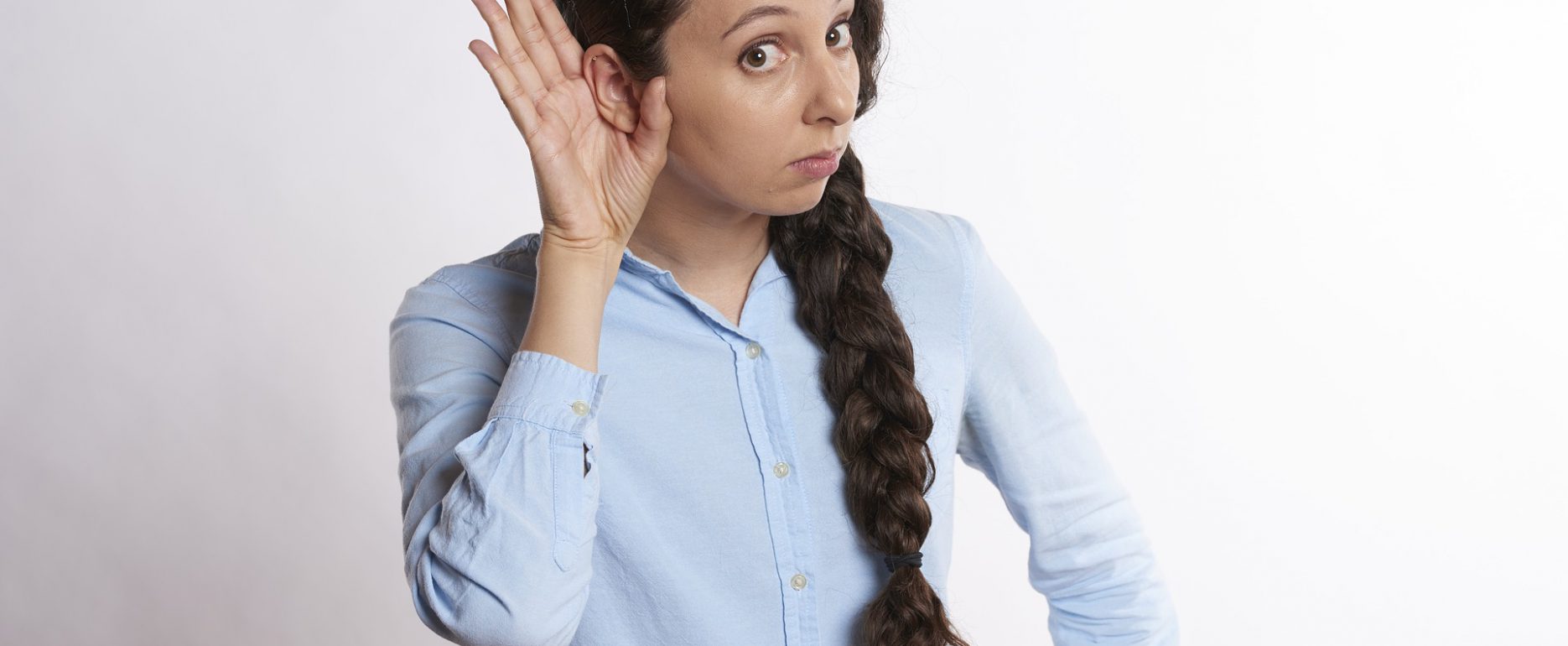 About Hearing Loss. Single-Sided Deafness with woman holding hand behind her right ear