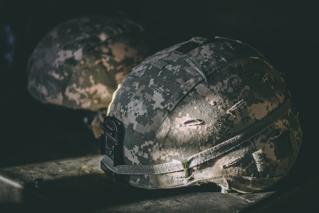 Two helmets next to each other. Why do my Ears Ring after the Military Service?